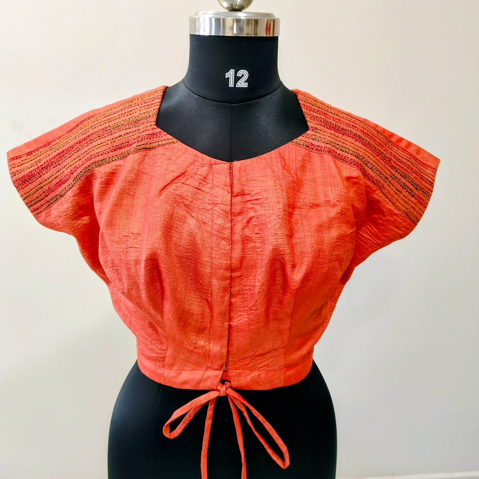 Where contemporary meets craftsmanship. Hand-embroidered shoulder detailing that speaks elegance in every stitch